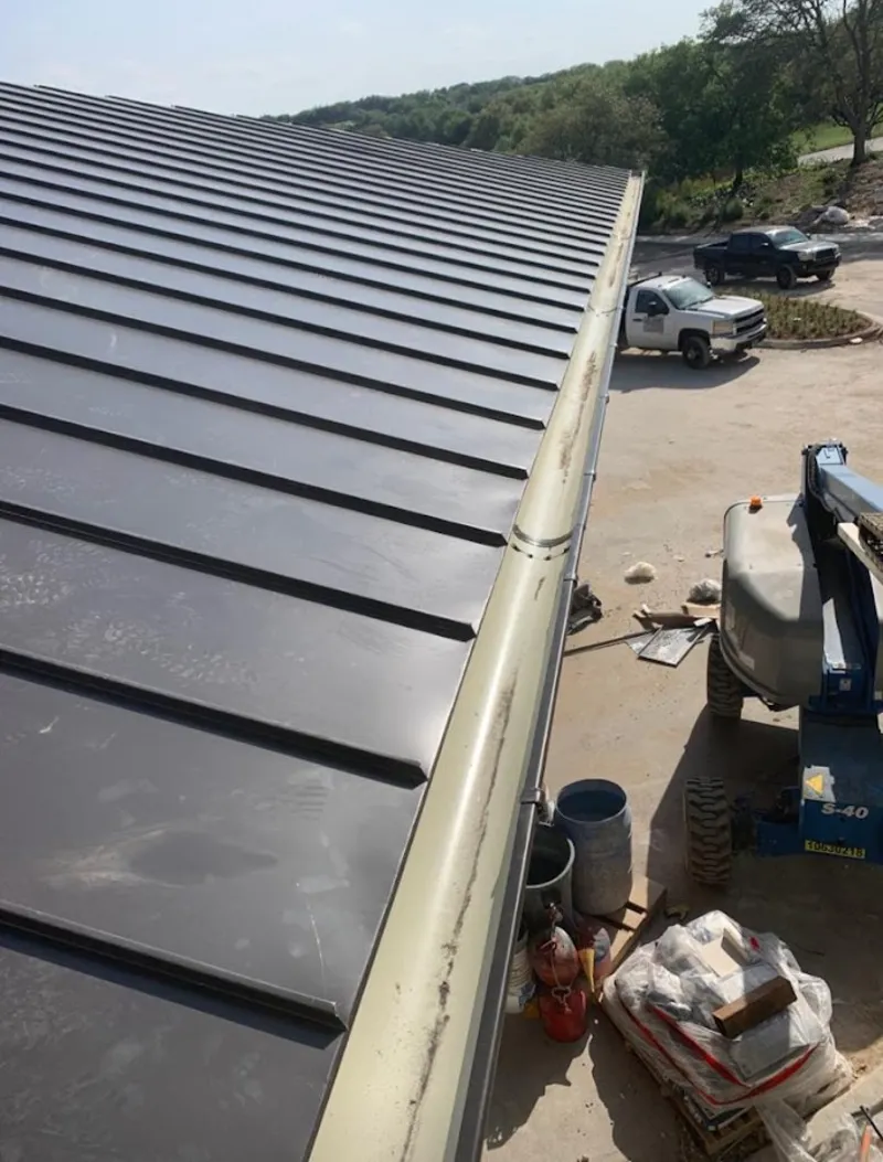 Standing seam panel and gutter detail on a metal roofing jobsite in Surprise